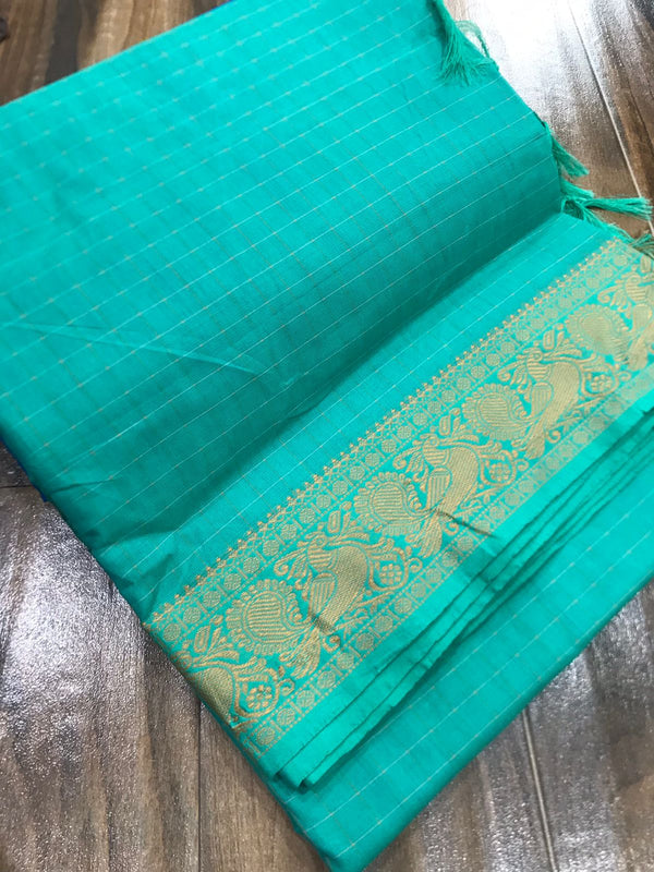 Spun cotton with tiny checks and single border with fantabulous peacock design