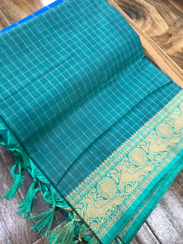 Spun cotton with tiny checks and single border with fantabulous peacock design