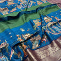 Pure Dola Saree – Royal Blue Mythological Print with Wine Purple Border & Rich Zari Weaving